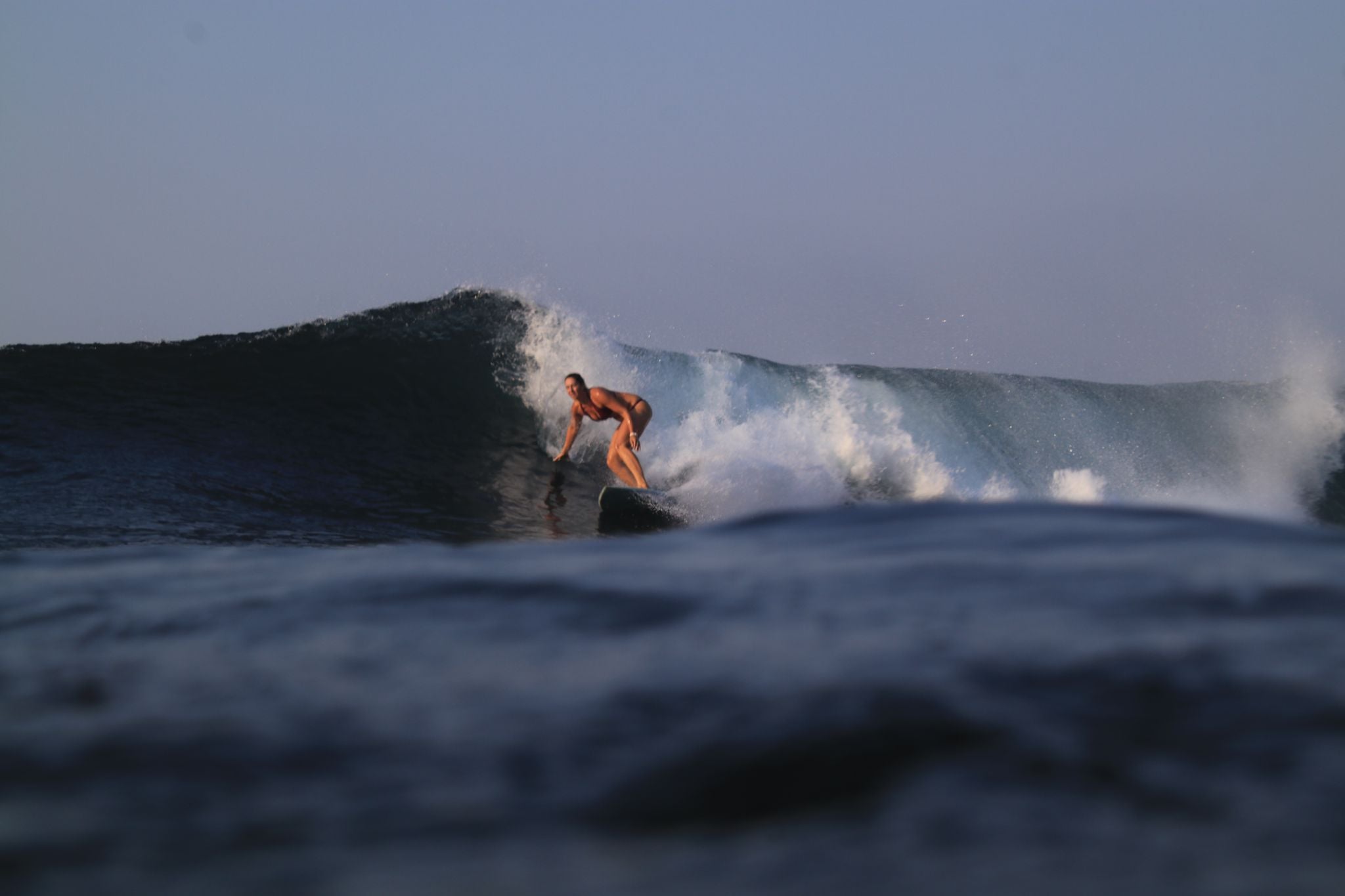 Woman surfing on wave