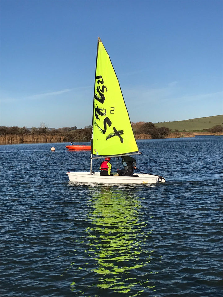 Sailing boat with green sail on Piddinghoe lake